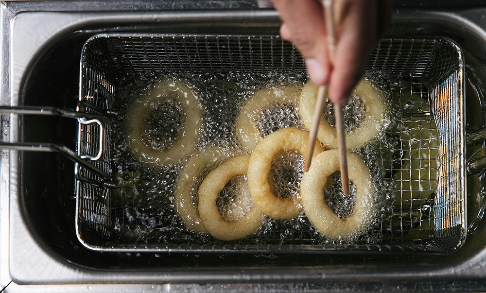 Somebody frying food in hot oil